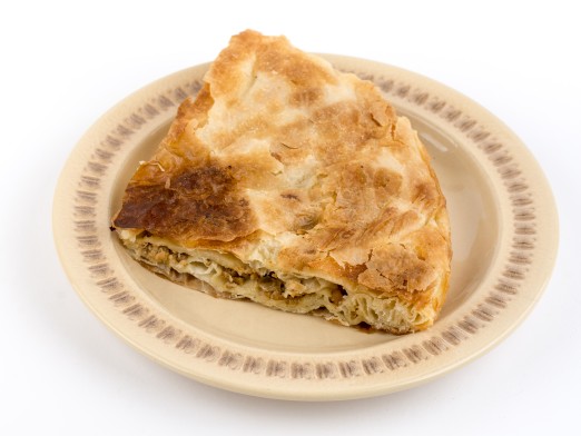 Traditional burek pie with meat isolated over white background.
